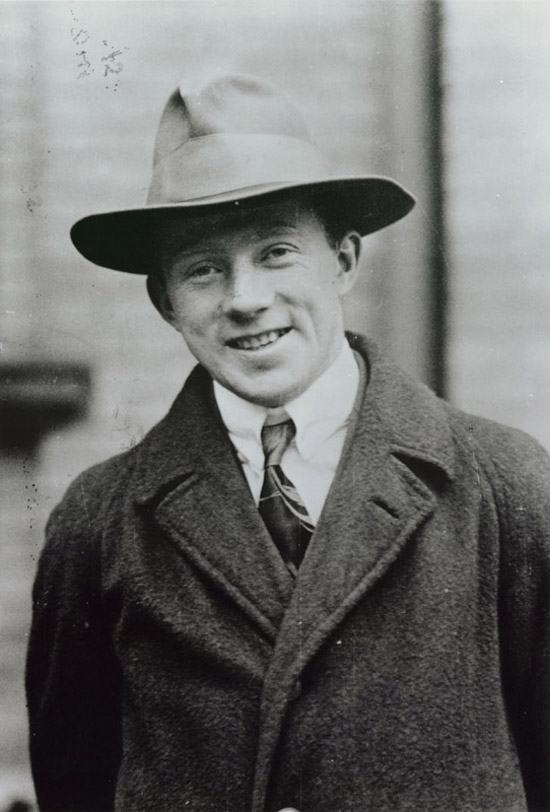 A photograph of a young, smiling Werner Heisenberg.